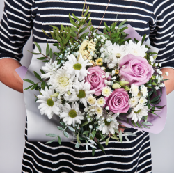 A bouquet of pink roses, white chrysanthemums, greenery and in beautiful packaging.